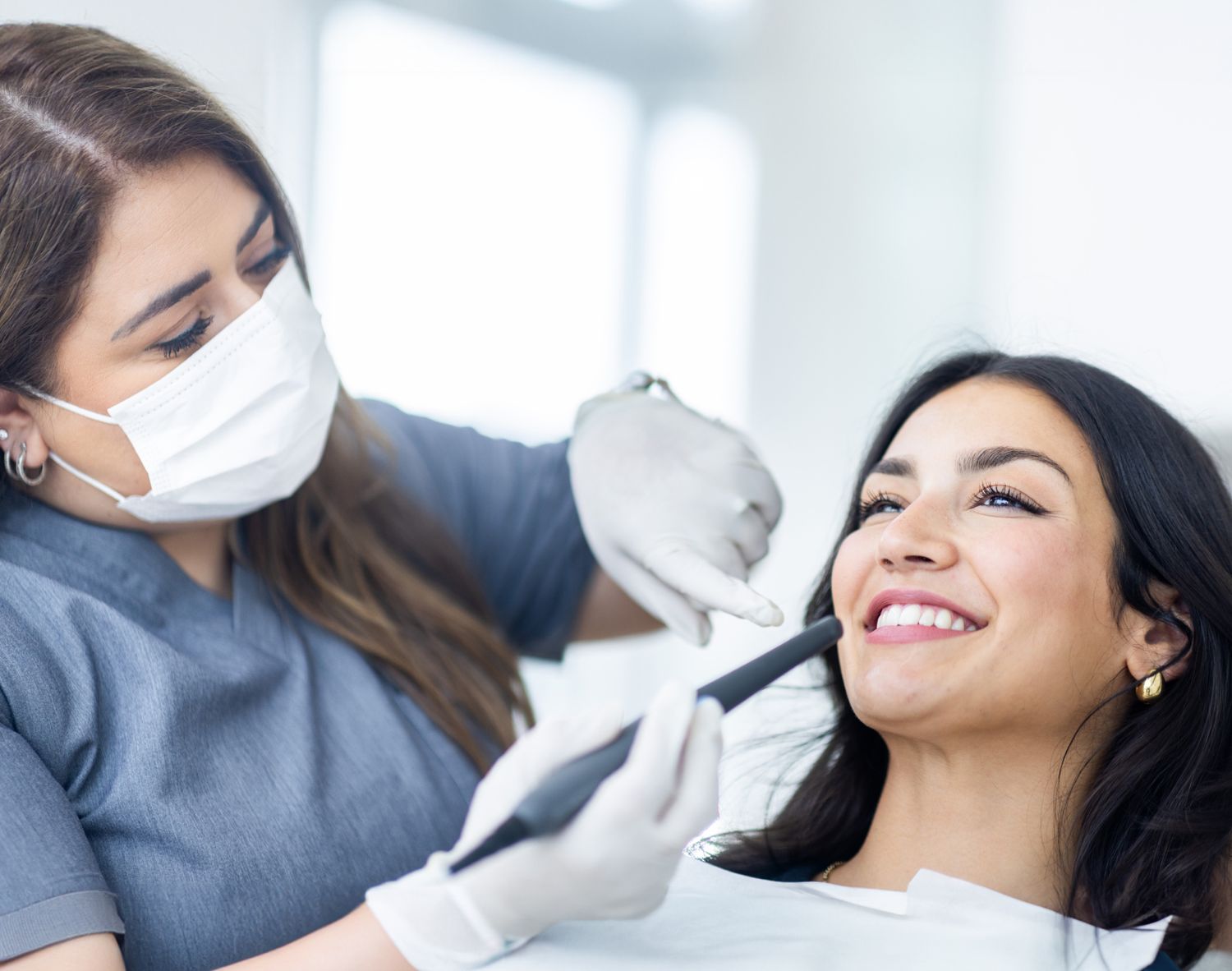 Dentist examining patient in modern dental office.