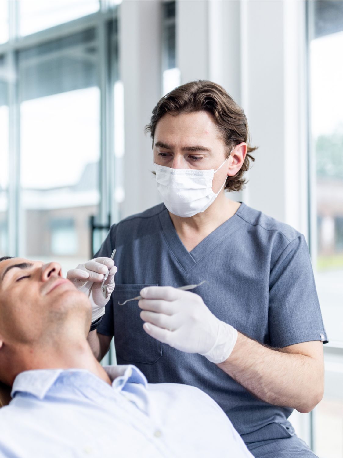 Dentist treating a patient in a modern office.